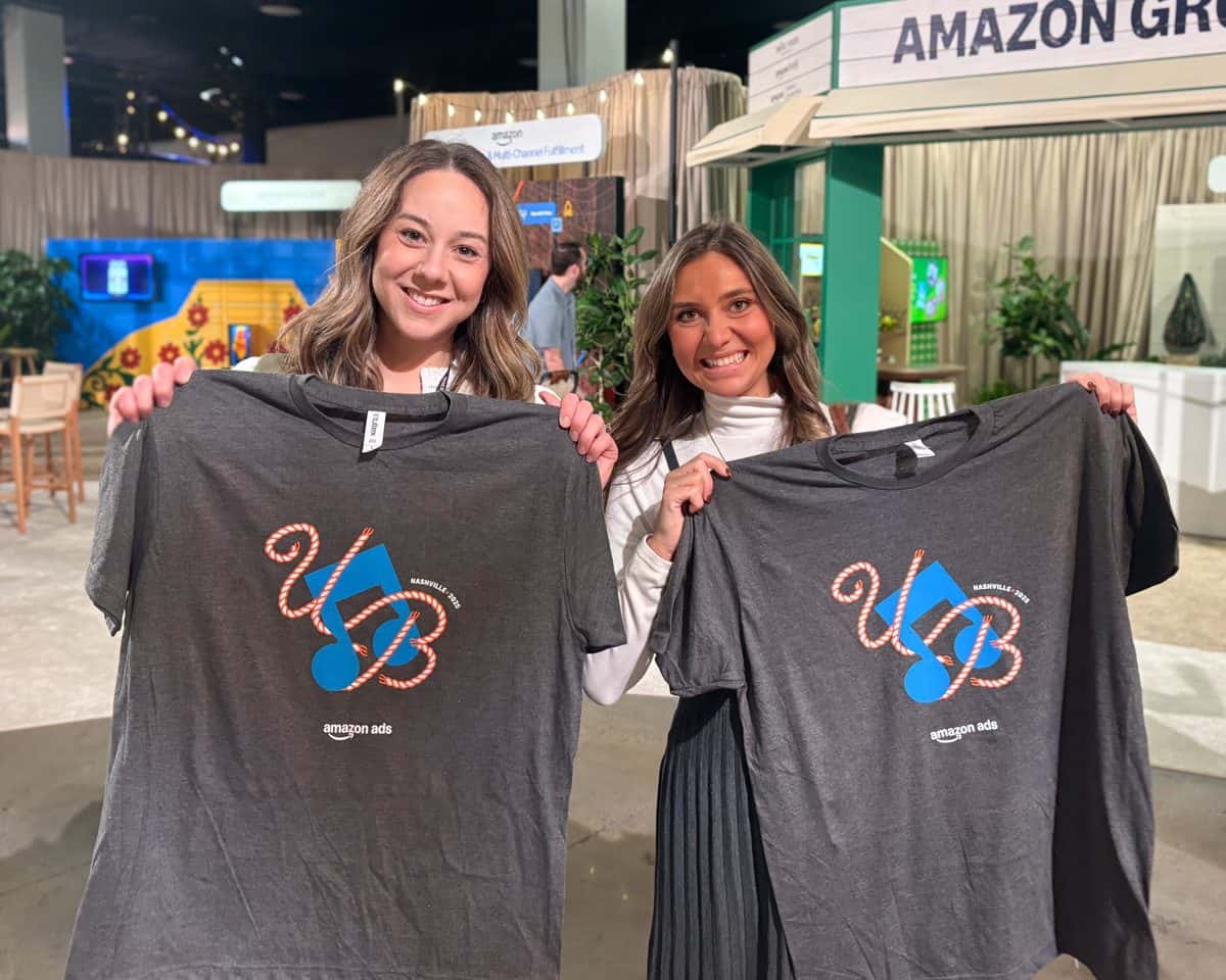 Guests holding freshly printed shirts