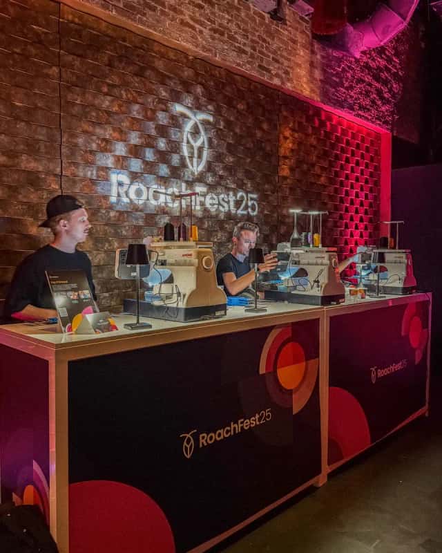 Live embroidery bar with three machines running at an evening event